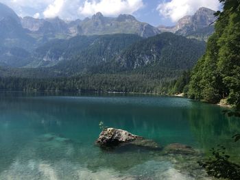 Scenic view of lake and mountains against sky