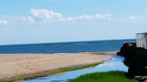 Scenic view of sea against blue sky