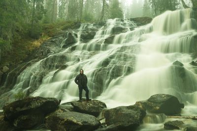 Man standing on rocks in forest