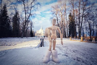 Close-up of statue on snow covered road