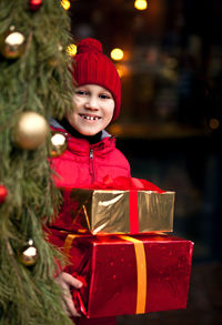 Portrait of woman holding christmas tree