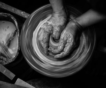 Cropped hands of person making pottery
