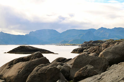 Rocks by sea against sky