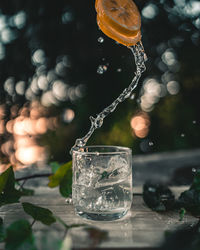 Close-up of drink pouring water in glass