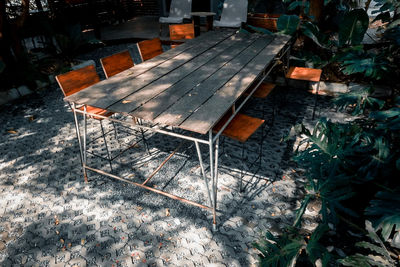 High angle view of empty chairs and table in yard