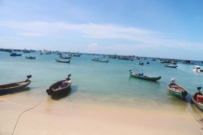 Boats moored on sea against sky