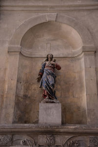 Low angle view of statue against building