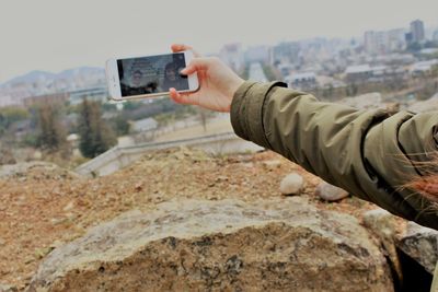 Man photographing camera on mobile phone