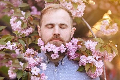 Close-up of man with purple flowering plants