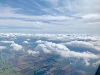 Aerial view of clouds over landscape against sky