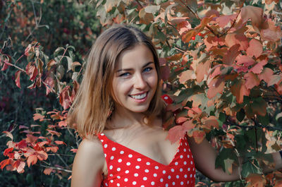 Beautiful girl in a red dress among the woods. snow-white smile. close-up. person