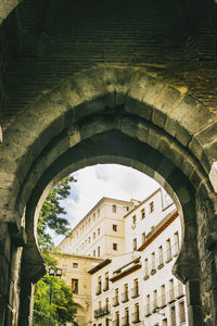 Low angle view of building seen through arch