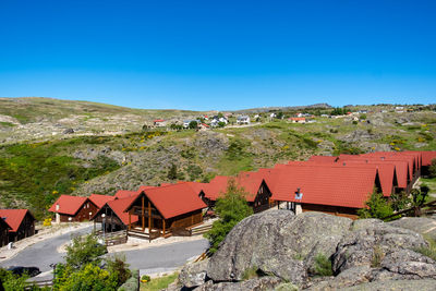 Houses and buildings against clear blue sky