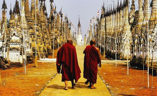 Rear view of people walking in temple