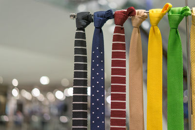 Close-up of neckties hanging in store for sale