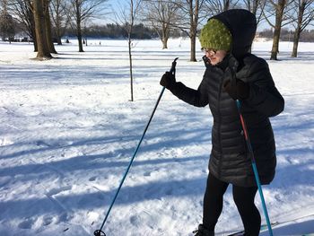 Woman skiing on snow covered landscape