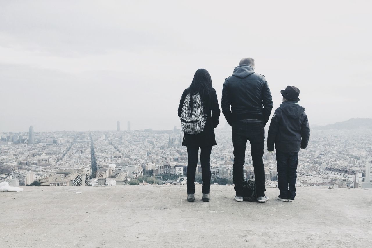 men, lifestyles, rear view, leisure activity, togetherness, full length, person, sky, standing, casual clothing, walking, city, bonding, love, landscape, friendship, cityscape, day