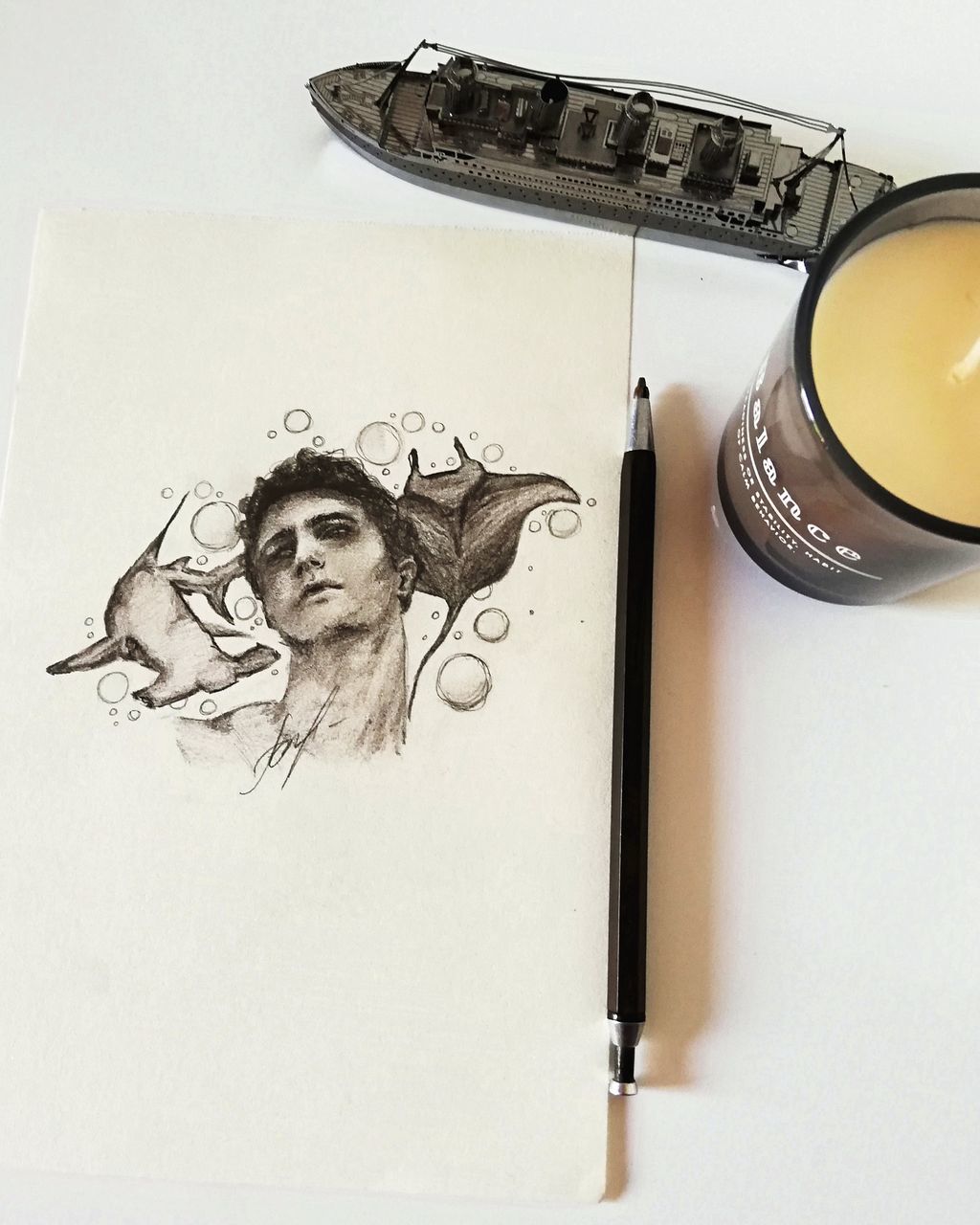 indoors, creativity, art and craft, representation, human representation, no people, male likeness, drawing - art product, still life, high angle view, female likeness, sketch, paper, paint, activity, table, pencil drawing