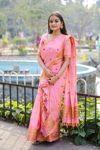 Portrait of smiling young woman standing outdoors