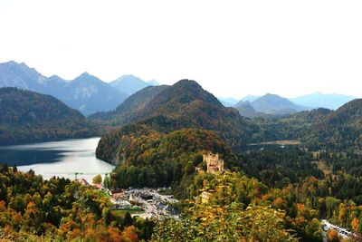 Scenic view of lake and mountains against clear sky