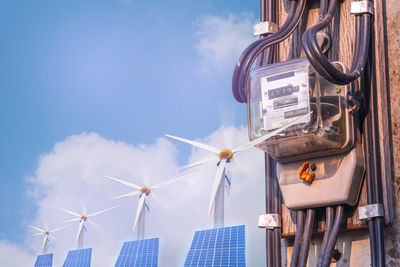 Low angle view of windmill against blue sky