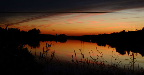 Scenic view of lake against romantic sky at sunset