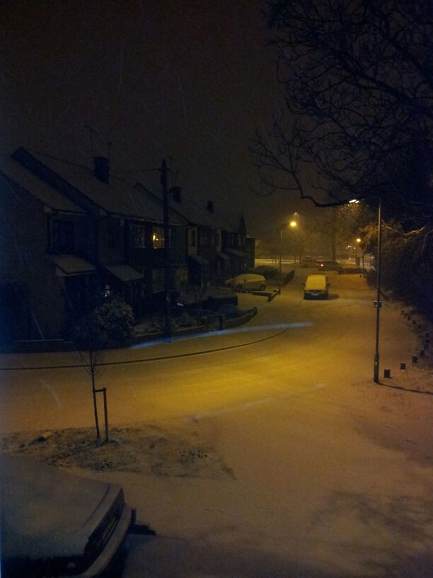 SNOW COVERED ROAD AT NIGHT