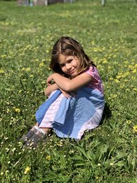 Portrait of a girl sitting on field