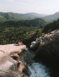 High angle view of woman sitting on mountain by diyaluma falls