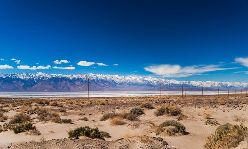 Scenic view of desert against blue sky