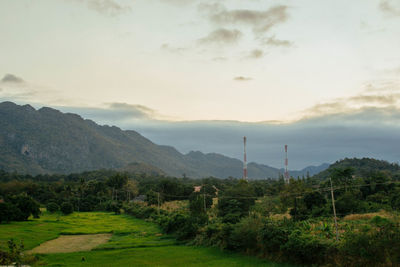 Scenic view of field and mountains against sky