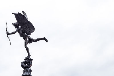 Low angle view of statue against sky