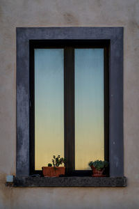 Low angle view of window on building against sky