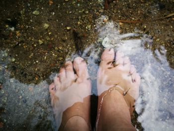 Low section of woman relaxing on beach