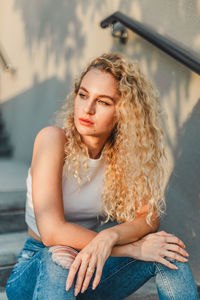 Portrait of young woman sitting outdoors