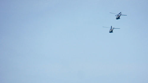 Low angle view of airplane against clear blue sky