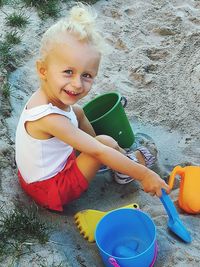 Portrait of cute girl sitting outdoors
