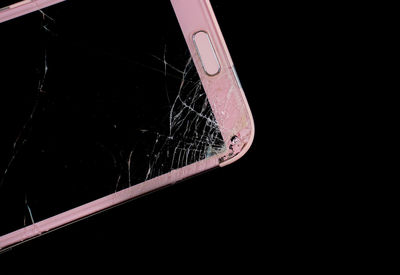 Close-up of broken glass against black background