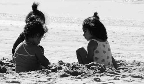 Rear view of women on beach