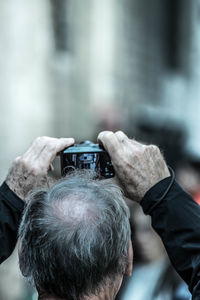 Rear view of man photographing