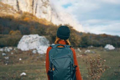 Rear view of man standing on rock