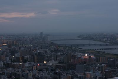 Illuminated cityscape against sky