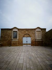 Entrance of historic building against sky