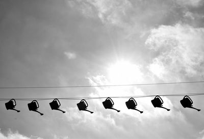 Low angle view of birds flying against sky