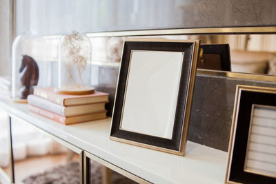 Close-up of blank frame on shelf at home