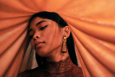 Close-up portrait of beautiful young asian woman with fabric props