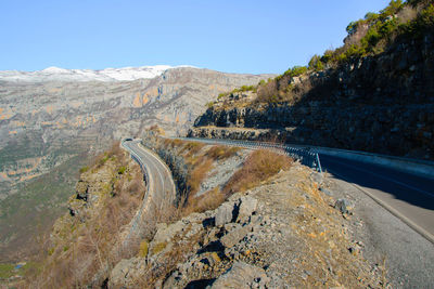 Aerial view of dam on road by river against clear sky