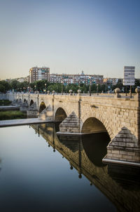 Bridge over river with buildings in background