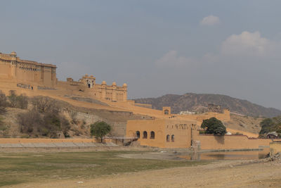 Built structure on landscape against sky