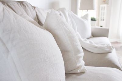 Close-up of white sofa on bed at home